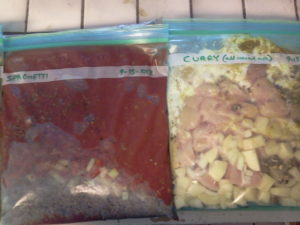Two gallon bags with food, flattened and ready to freeze.