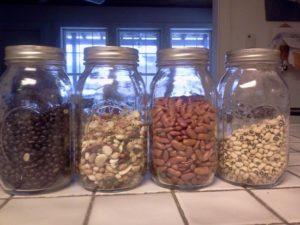 Quart mason jars with black beans, white beans, red beans, and mixed beans